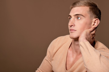 Fototapeta premium Thoughtful handsome young man posing in studio