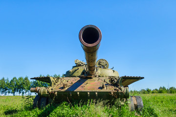 Barrel of battle tank aimed above as it would shoot
