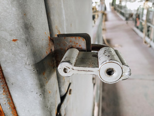 A metal old rusty lock with a keyhole hangs on a door, a gate. Photography, concept.