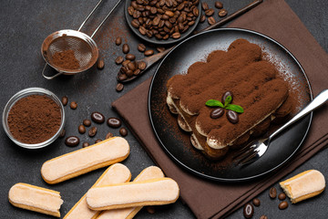 Classic tiramisu dessert and savoiardi cookies on ceramic plate on concrete background