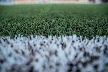 Abstract background green grass field with lights blurred bokeh.