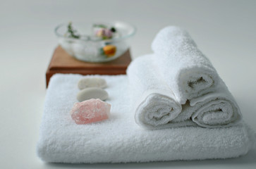 white cotton towels and mineral stones, spa accessories for body care