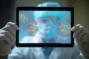 Portrait of modern researcher is using futuristic screen with augmented reality coronavirus hologram for viewing results of research in laboratory.Concept of future, science, coronavirus, pandemia