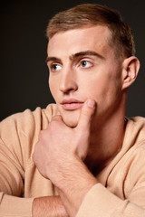 Thoughtful handsome young man posing in studio