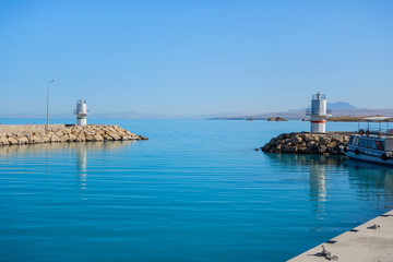 Lighthouses at end of dam that surrounding bay of tourist boats, Van Lake, Gevaş, Turkey. Bright...
