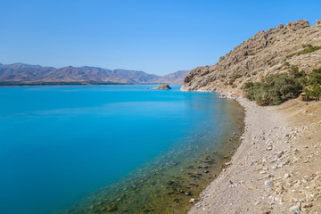 South coastline of Akdamar Island on Van Lake, Gevaş, Turkey. Clear water & its very bright blue colour created by soda elements in its consist. It's popular tourist destination among locals & foreign