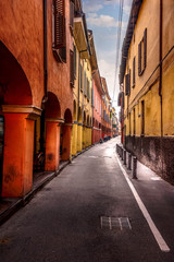 Portrait view of a colorful street in Bologna, Italy.