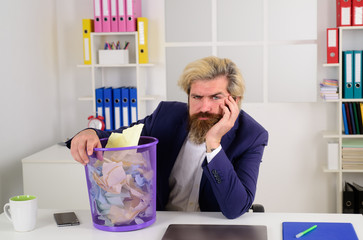 Office worker. Ceo. Bearded businessman in a blue suit with trash can in the office. Office worker,...