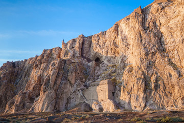 Fototapeta premium Panoramic view onto ancient Van Rock with its famous fortress Tushpa on top, Van, Turkey. Remains of buildings of Old city of Van are below. Settlement was founded here by Urartians in 9 century BC