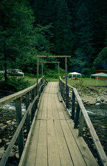 Fototapeta premium wooden bridge over the river in the woods 
