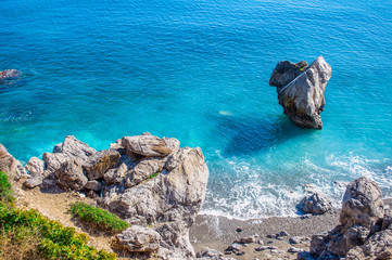 Preveli beach on Crete island with clear water, Greece, Europe. Stone on the sea with heart shape, waves and rocks around. 