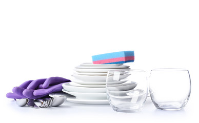 Clean tableware with sponge and gloves on white background