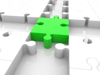 A piece of green puzzle in the center between the crossroads of a white puzzle