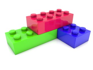 Toy bricks, green, blue and red on white