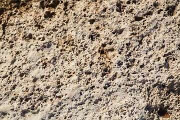 Terrain gravel wall. Rocky hill. Light beige abstract textured background. Surface. Cracked rock stones. Copy space