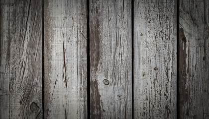 Old wooden wall with weathered and peeled white paint