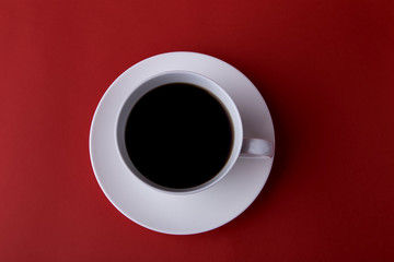 
Expresso coffee in a white cup on a red background, minimalism, close-up
