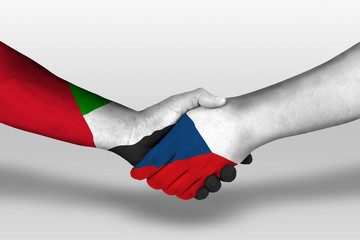 Handshake between czech republic and united arab emirates flags painted on hands, illustration with clipping path.