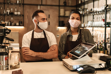 Coffee shop owners with face masks, lockdown, quarantine, coronavirus, back to normal concept