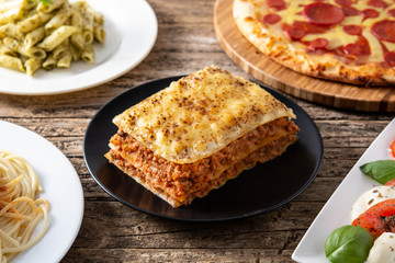 Assortment of Italian pasta dishes on wooden table