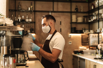 barista equipped with a protective mask for the virus