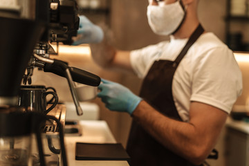 barista equipped with a protective mask for the virus