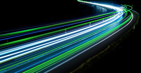 green, blue and white car lights on the road at night