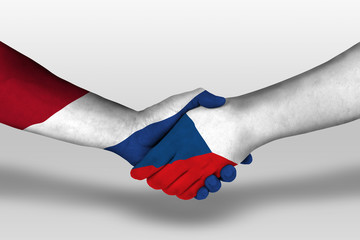 Handshake between czech republic and netherlands flags painted on hands, illustration with clipping path.