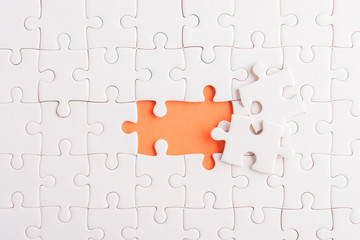 Top view flat lay of paper plain white jigsaw puzzle game texture incomplete or missing piece,...