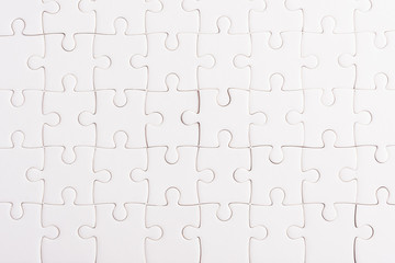 Top view flat lay of paper plain full white jigsaw puzzle game texture background, quiz calculation...