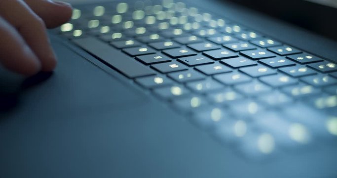 Black Laptop Trackpad. Person types and navigates with the trackpad and hits the spacebar several times on a laptop.