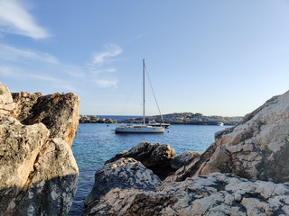 Sailboat mooring in a small cove of beach Velo Zarace on Hvar island, Croatia in sunset.