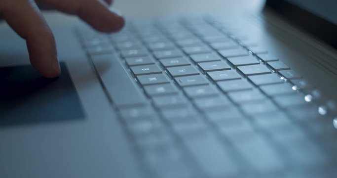 Gray Laptop Trackpad. Person types and navigates with the trackpad and hits the spacebar several times on a laptop.