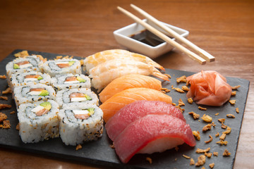 Closeup of typical Japanese sushi on wooden background.