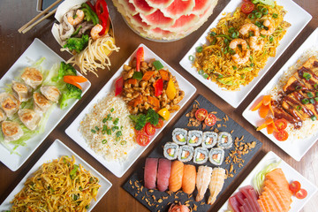 Typical Chinese food top view on wooden background.