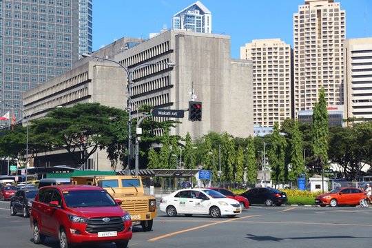 MANILA, PHILIPPINES - NOVEMBER 28, 2017: People drive in heavy traffic in Makati City, Metro Manila, Philippines. Metro Manila is one of the biggest urban areas in the world with 24 million people.
