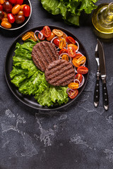 Fried cutlet for burger with vegetables.