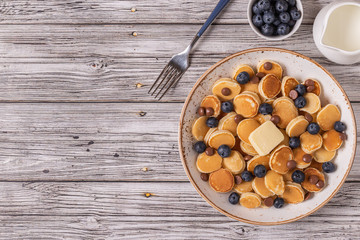 Trendy breakfast with mini pancakes, blueberries and chocolate chips.