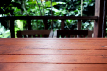 Naklejka premium wood table on blur of cafe, coffee shop, bar, resturant, background - can used for display or montage your products