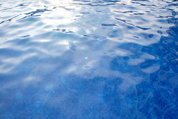 Hotel swimming pool with sunny reflections