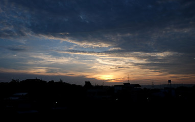 Sunset sky background with clouds and sun, photo image wallpaper.