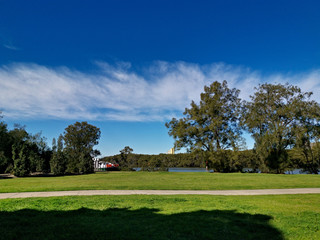 Beautiful view of a park with green grass, tall trees and paved trail for walking and cycling, Reid Park, Parramatta Cycleway, Rydalmere, Sydney, New South Wales, Australia
