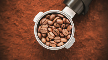 Against the background of ground coffee is a holder from the coffee maker, in the filter of which...