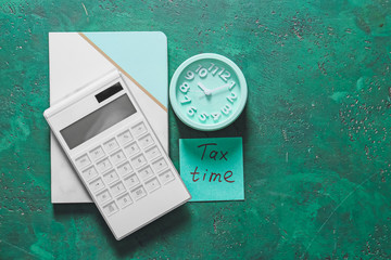 Alarm clock with calculator on color background. Concept of tax deadline
