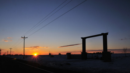 Sunrise over the plain in the front range in the area of Boulder Colorado with a ranch gate in the...