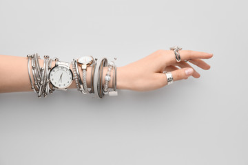 Female hand with stylish wrist watches on white background - Powered by Adobe