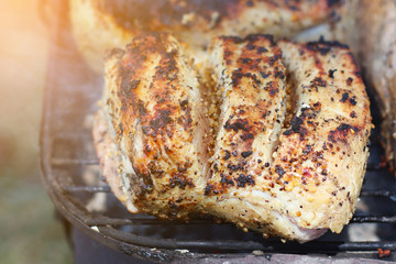 Pork steak grilling on a summer barbecue. BBQ background.