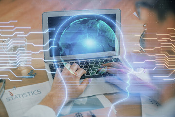 Man typing on keyboard background with brain hologram. Concept of big Data.