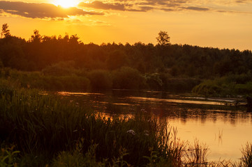 orange sunset over the river. sunset over the river. beautiful warm summer red sunset