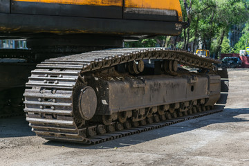 Fototapeta na wymiar Close-up of a heavy duty tractor track or military vehicle while parked